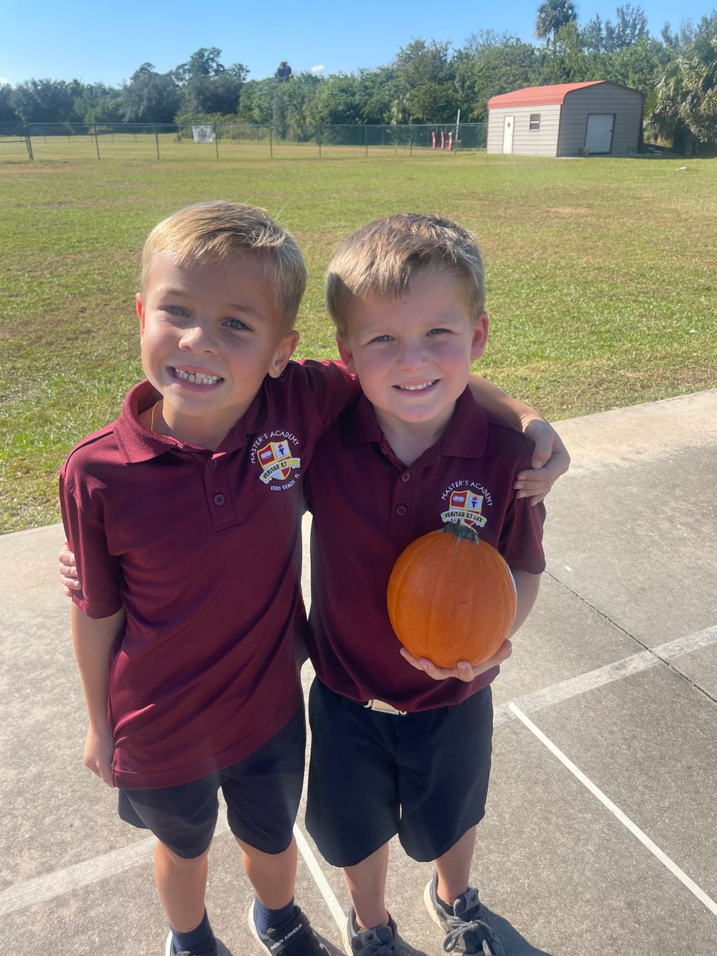 students holding pumpkin