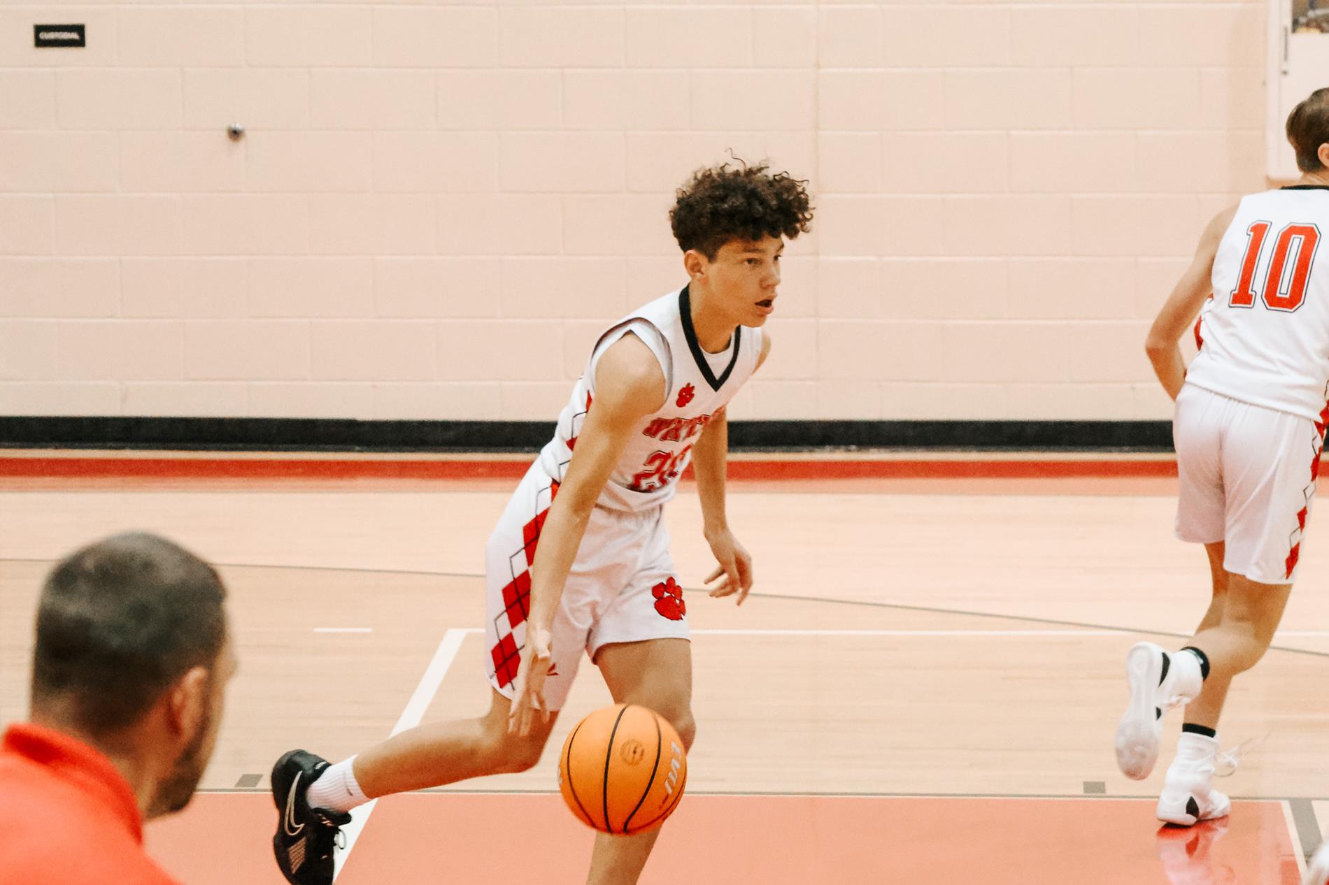 Boys basketball player dribbling ball