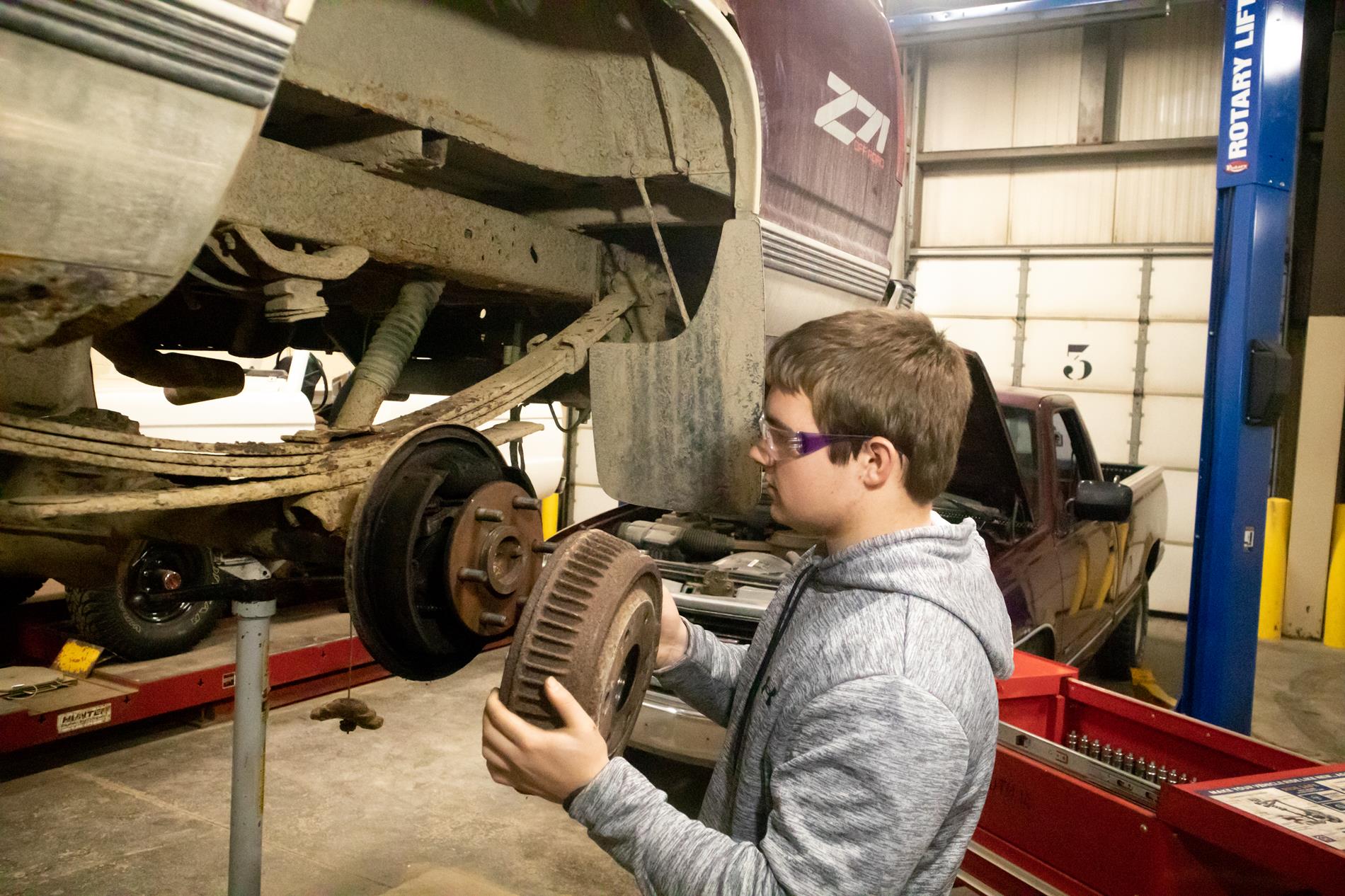 Students work on clients' cars throughout the week.