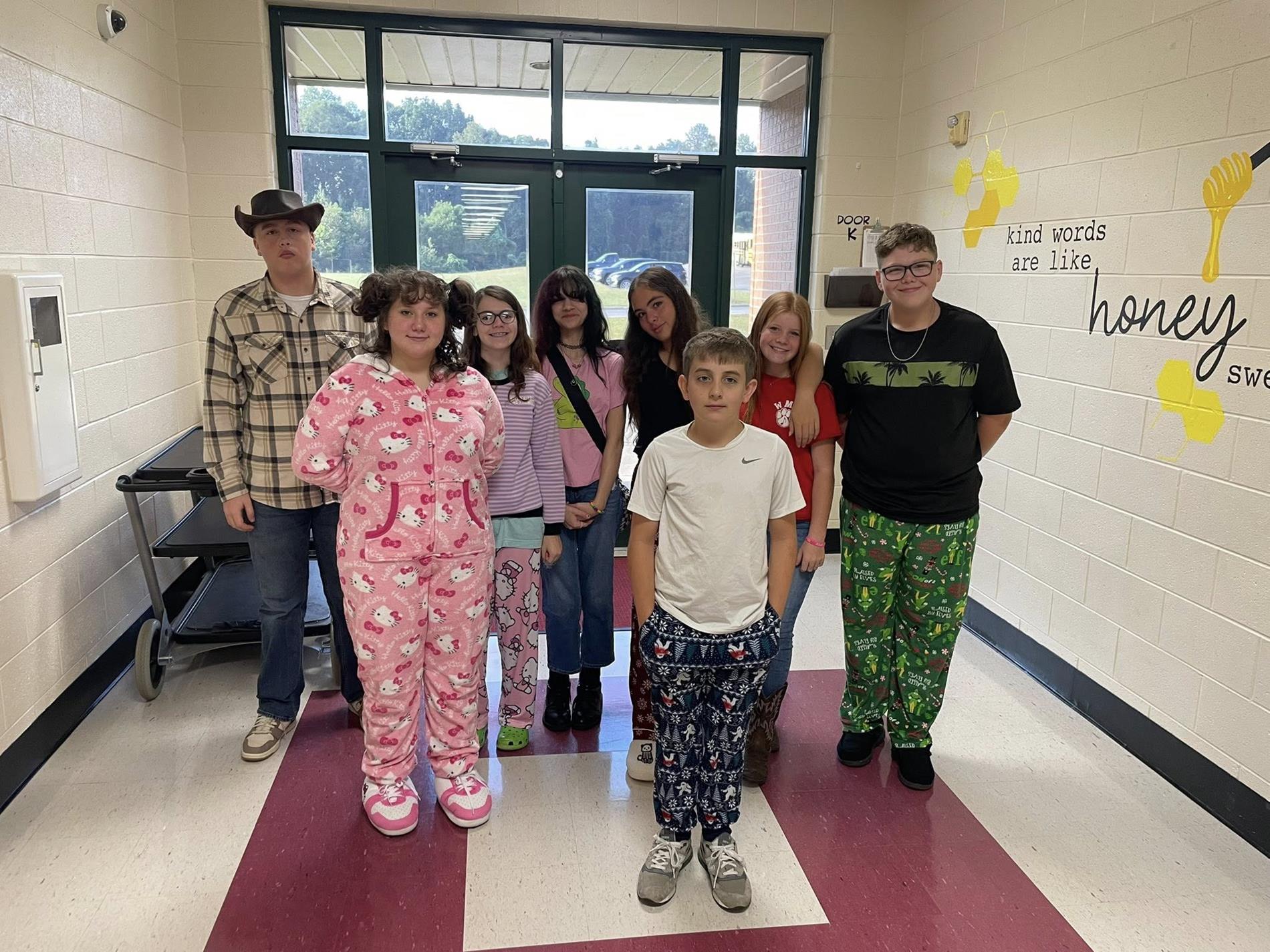 Group of students dressed in different pajamas being their "younger self" for homecoming.