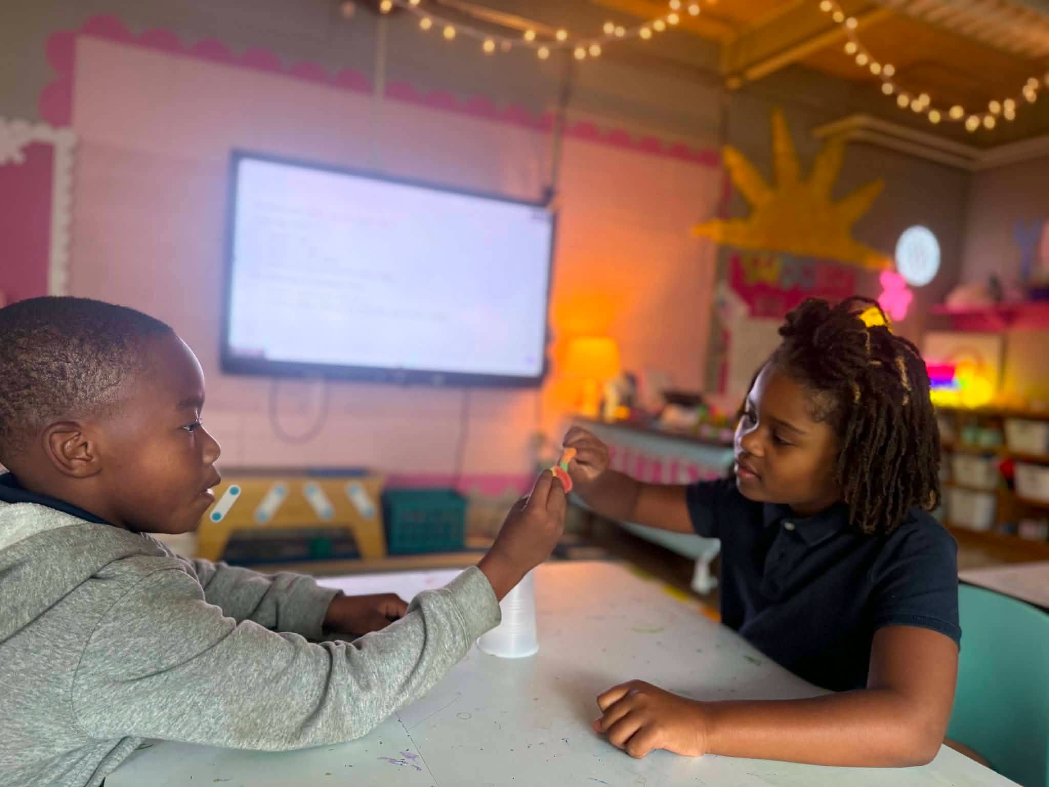 Two Church Hill Elementary Quest students collaborate on the Save Fred STEM challenge at a classroom table.