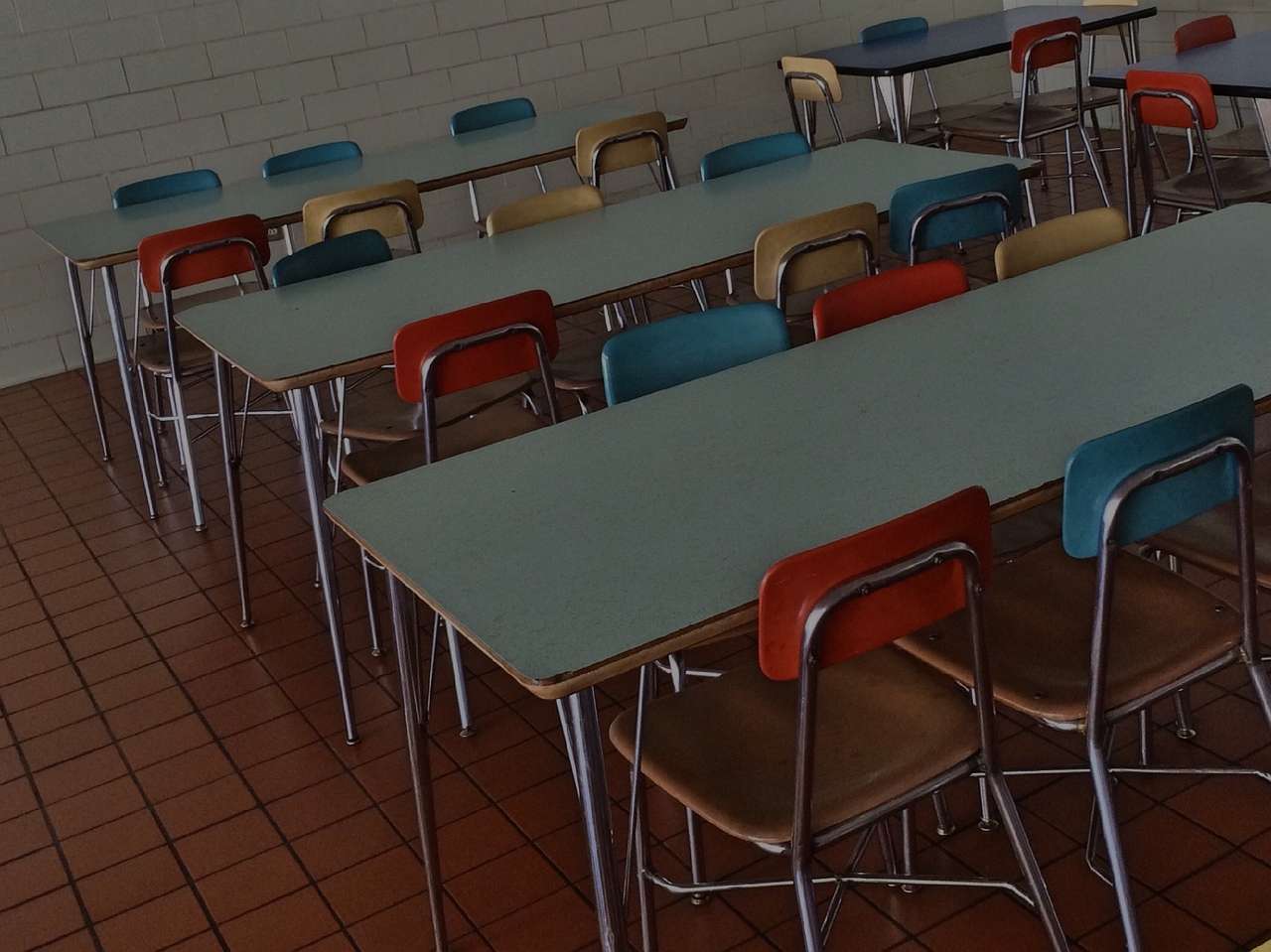 empty school cafeteria with chairs and tables