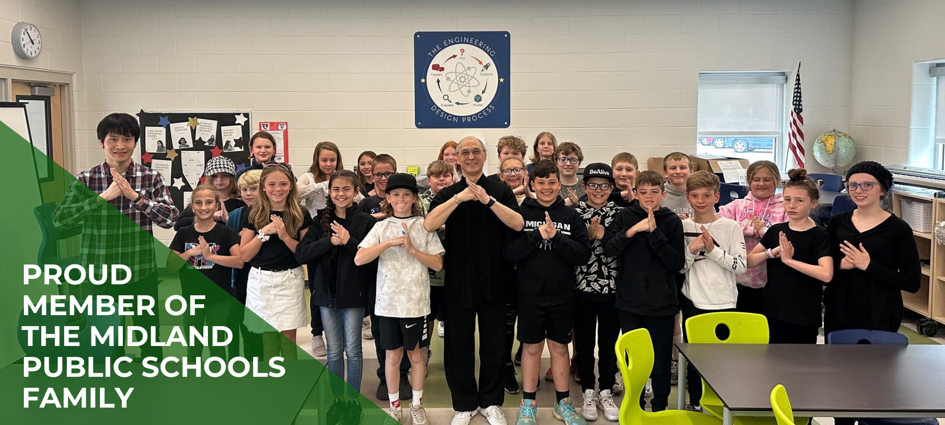 Teacher and Students in a classroom with text saying "proud member of the midland public schools family"