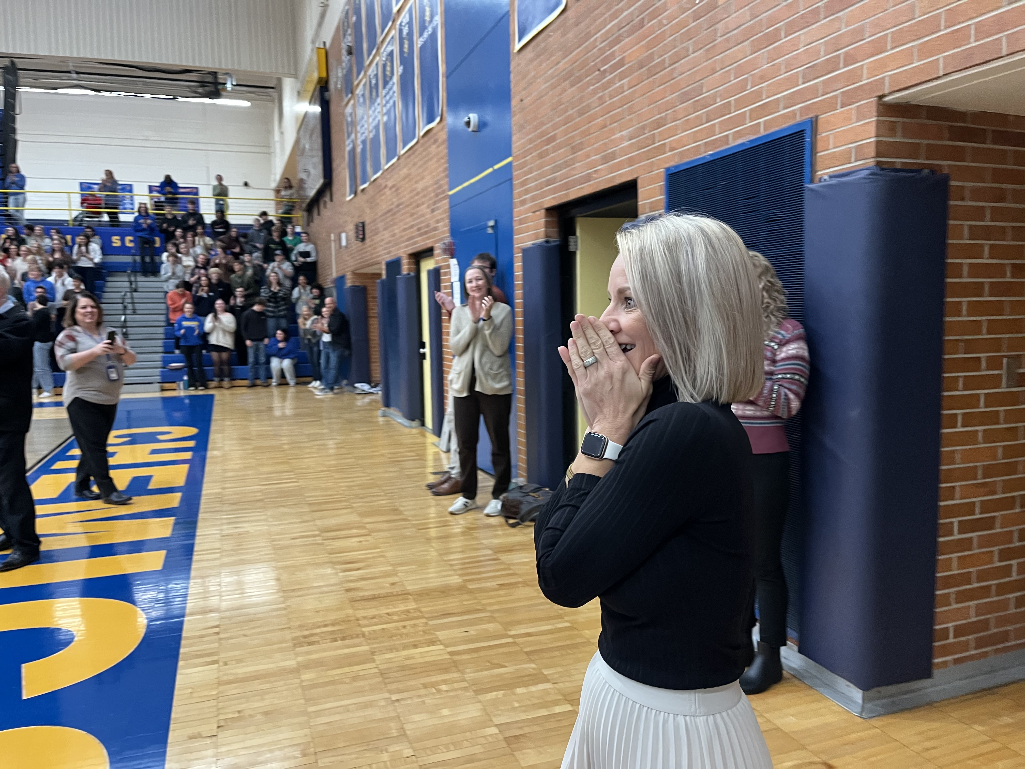 Tiela walks into the gym surprised by the fanfare