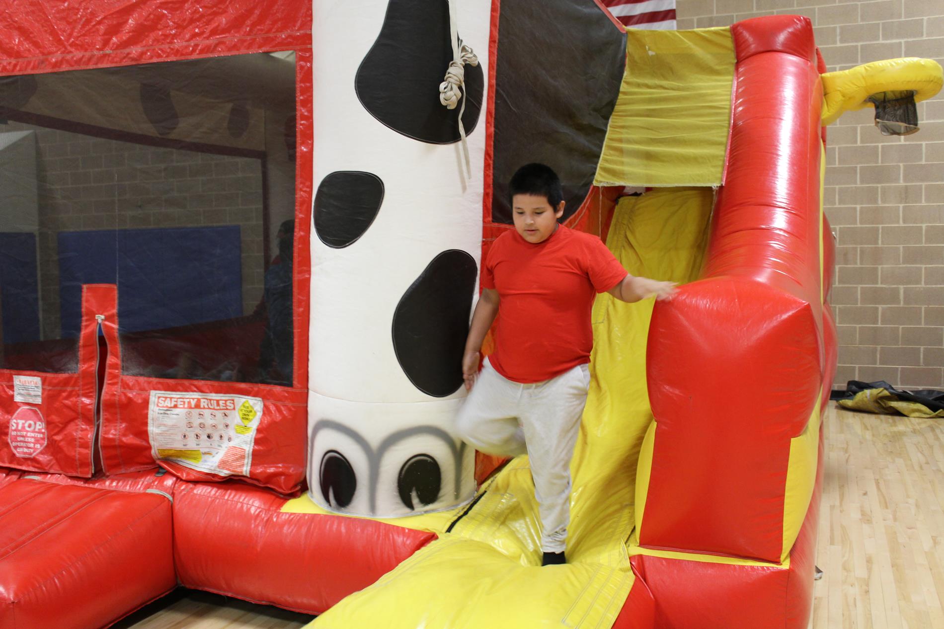 student walking out of the dalmatian jumpy house