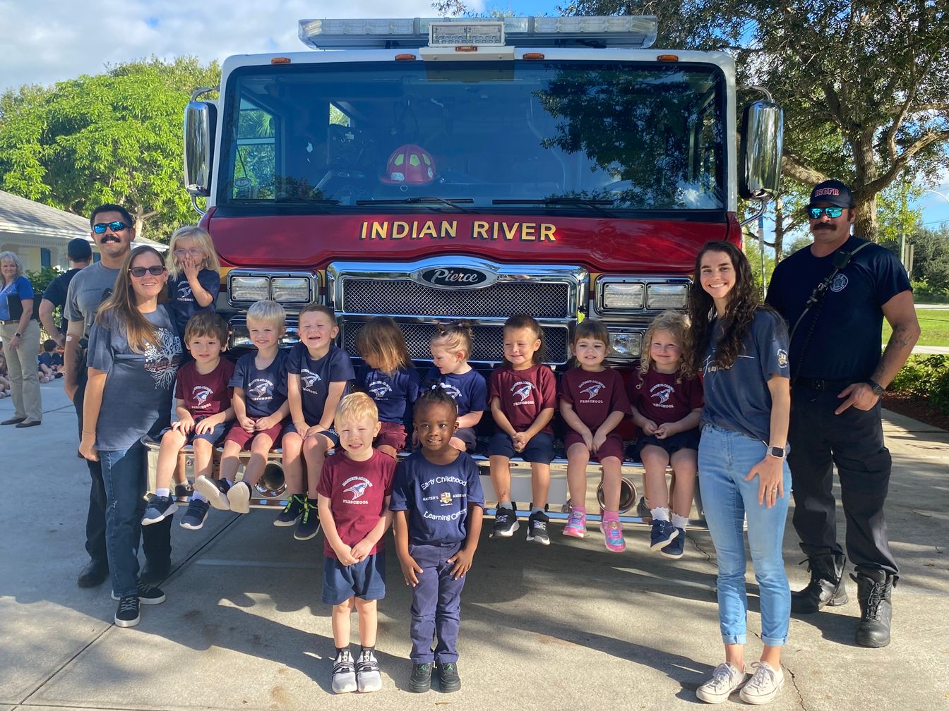 children posing on a firetruck 