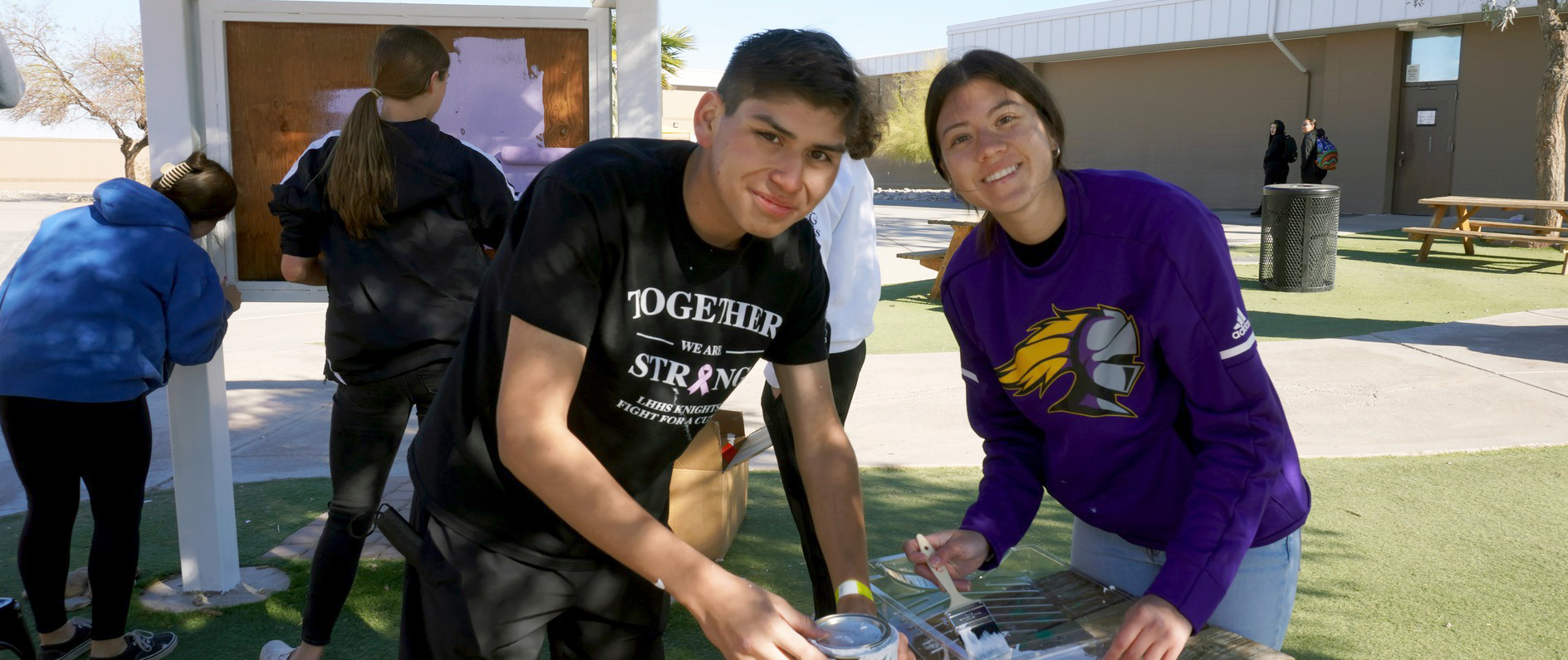 Students refresh painted sign during 2022 Day of Service