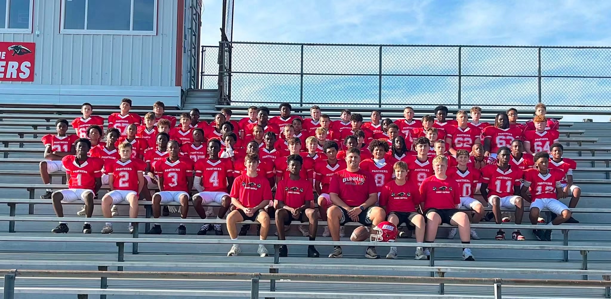 Bunkie junior high football team in red jerseys with coaches