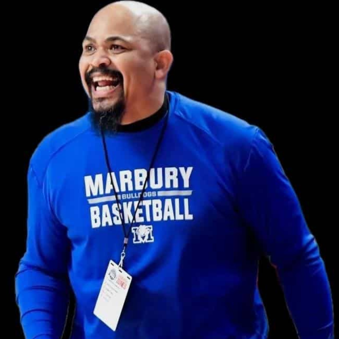 Coach Reggie Brown in Blue Shirt on Basketball Sidelines