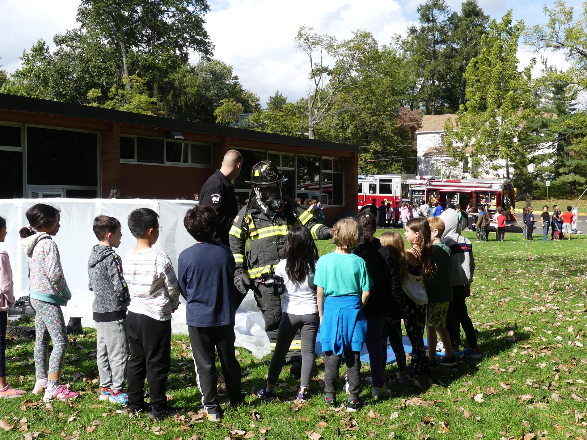 Students talking to fire fighter