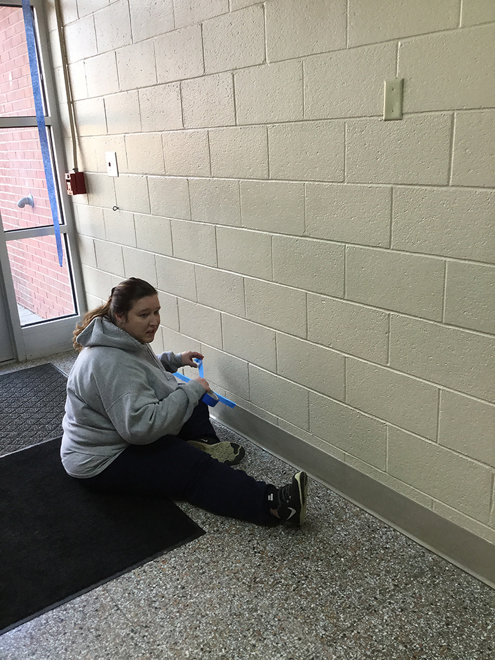 Students volunteering to help paint