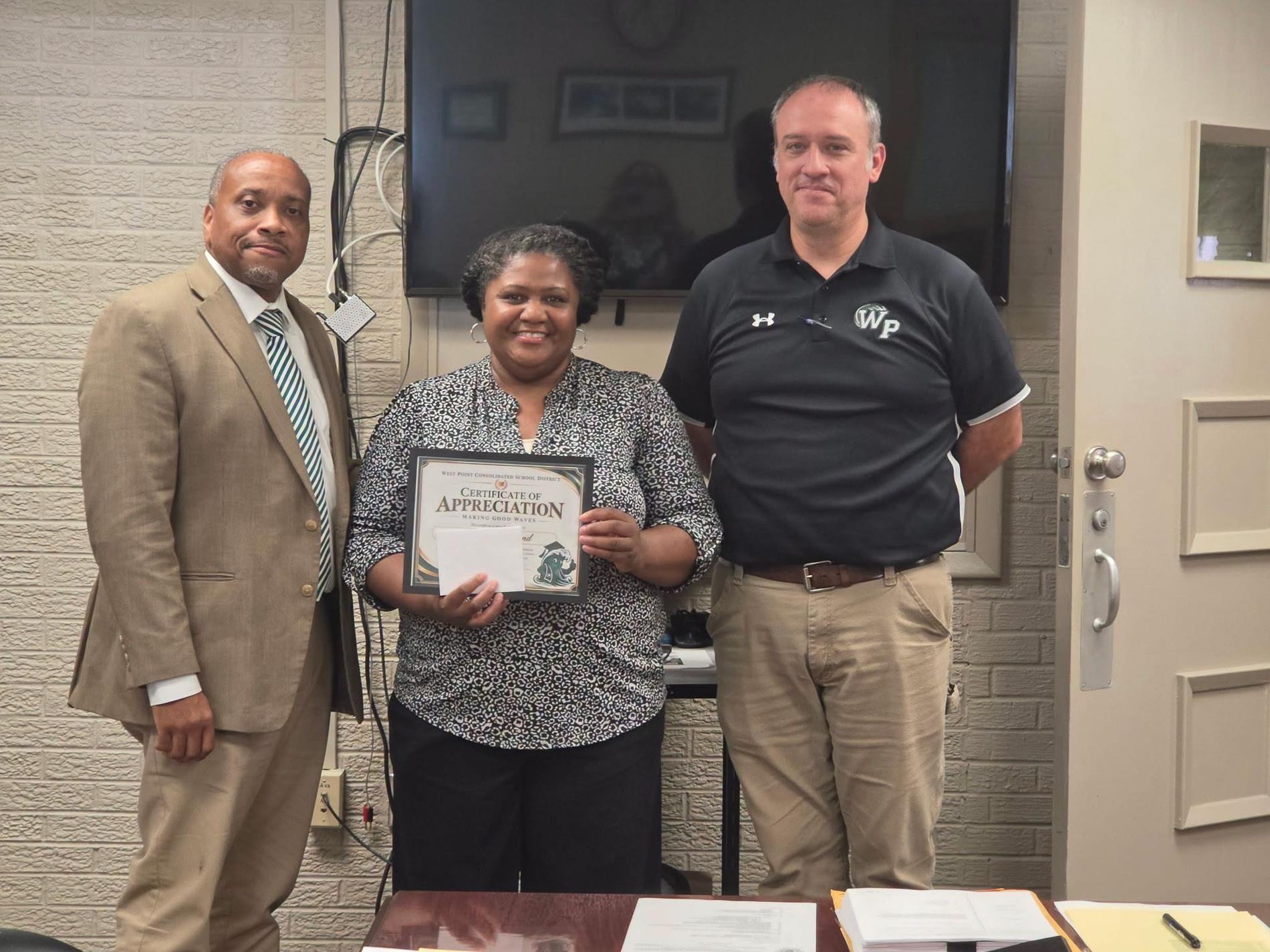 WPCSD Superintendent Dr. Jermaine Taylor and CTC Principal Patrick Ray standing with Career and Technology Center Counselor Tracey Hammond as she holds her Making Good Waves certificate of appreciation.