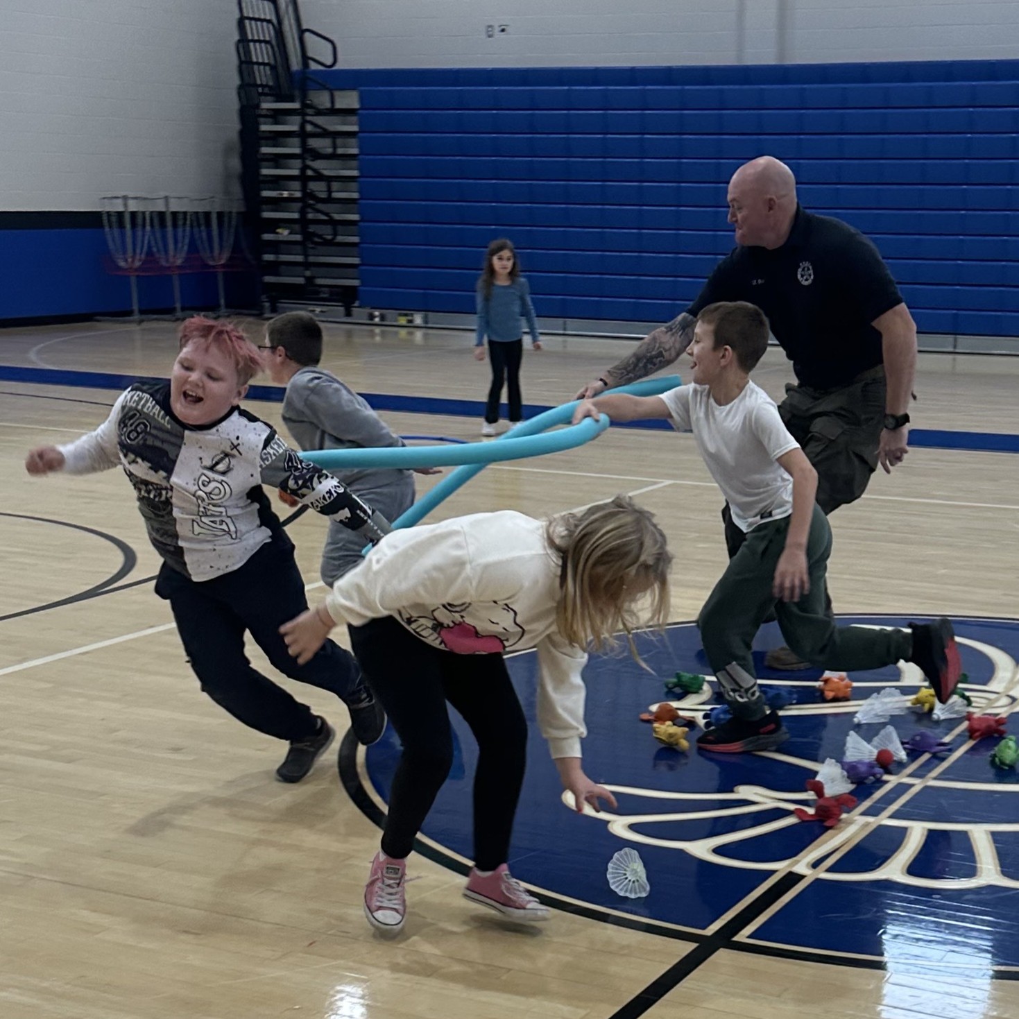 Students playing tag in gym