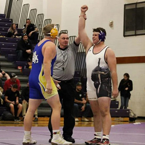LHHS Boys wrestler arm lifted as the winner of his round