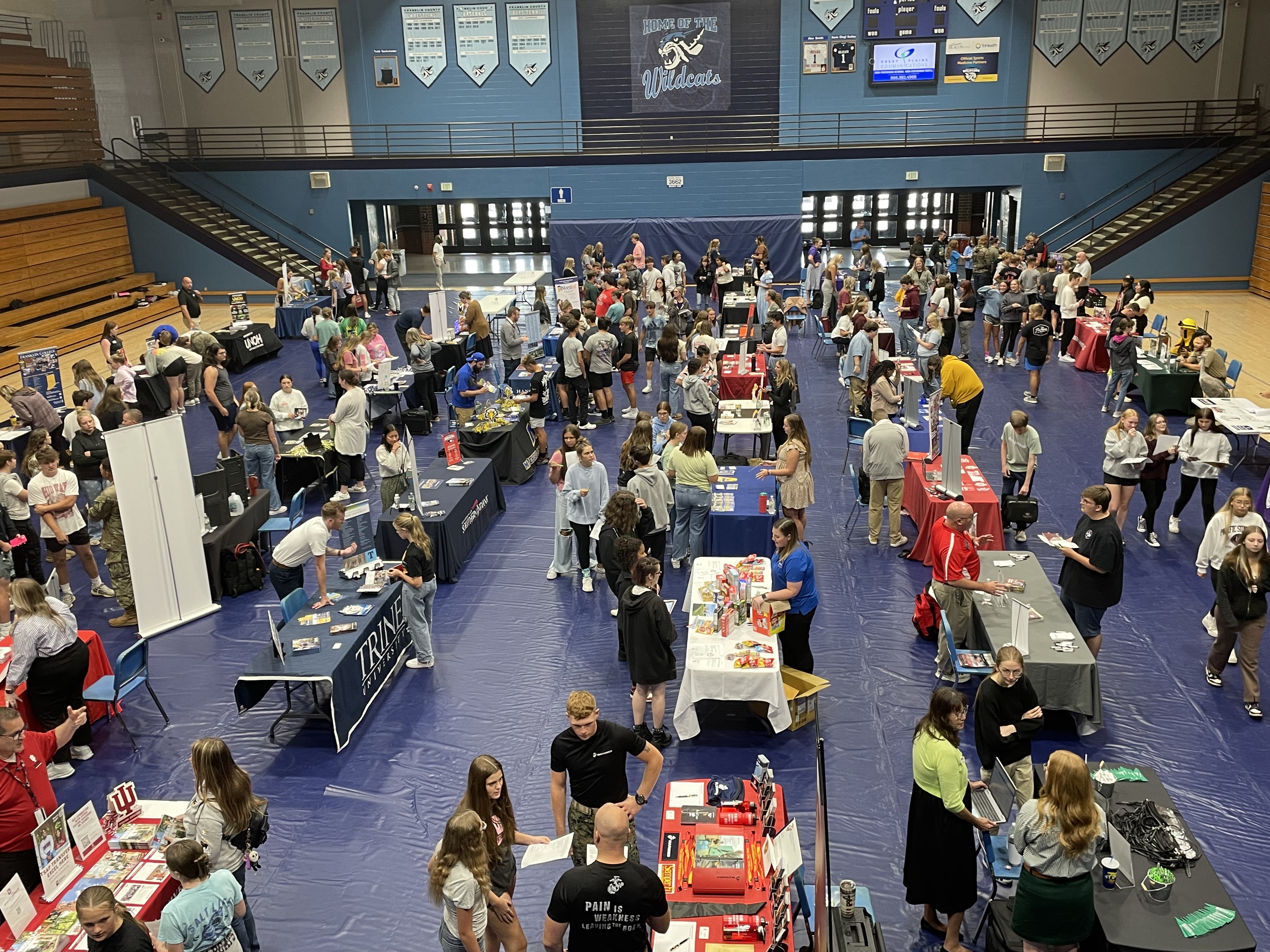 tables set up with students and college representatives