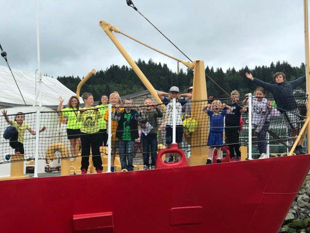 Students standing on the Columbia Light Ship at the Maritime Museum