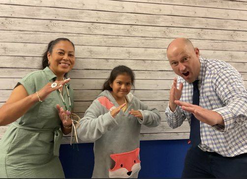 Leupp staff members celebrating with a fourth grade student