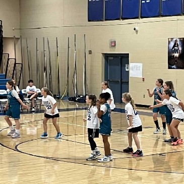Girls team playing basketball