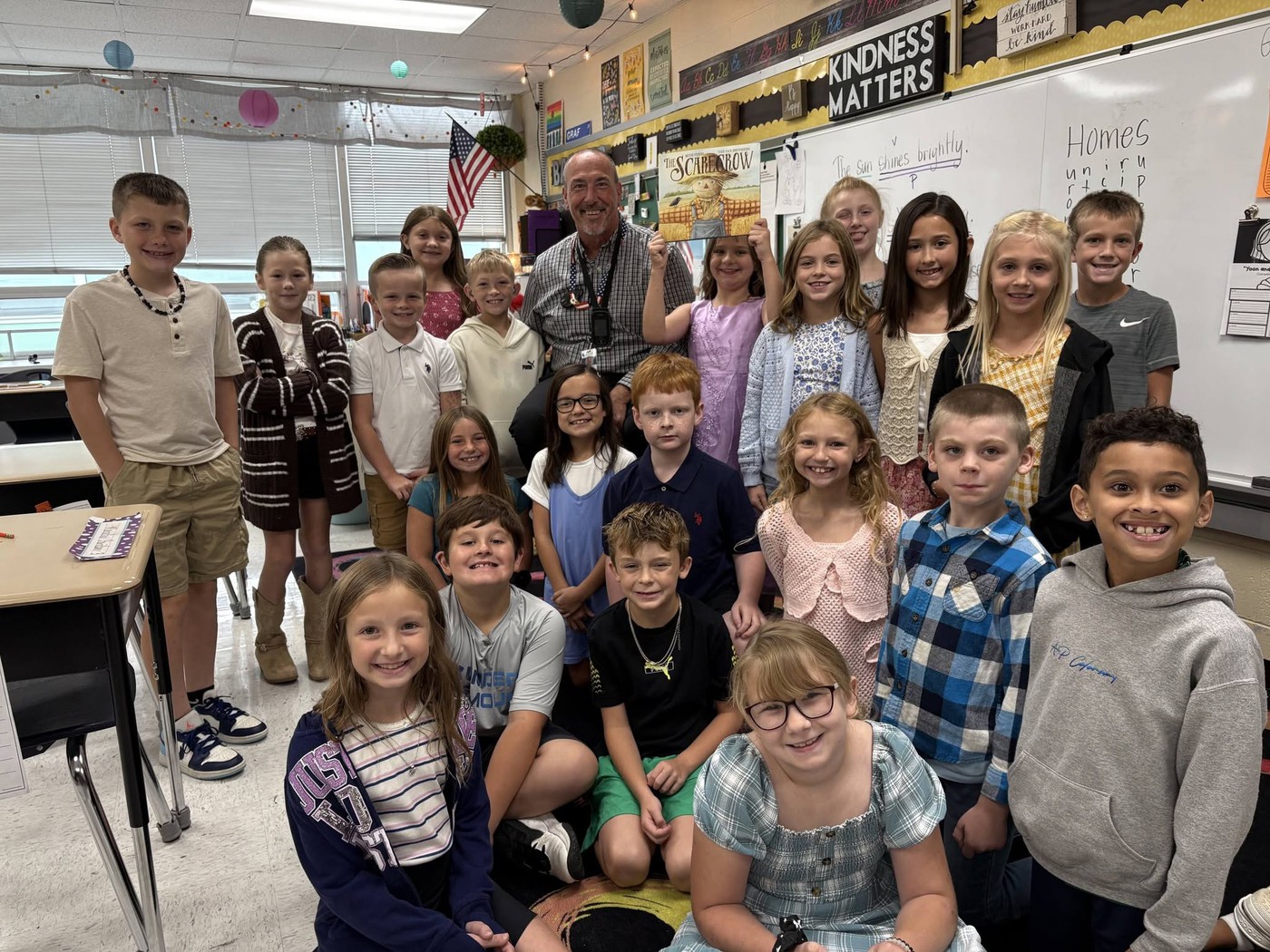 Mr. Piening reads to Mrs. Barnes 3rd grade class.