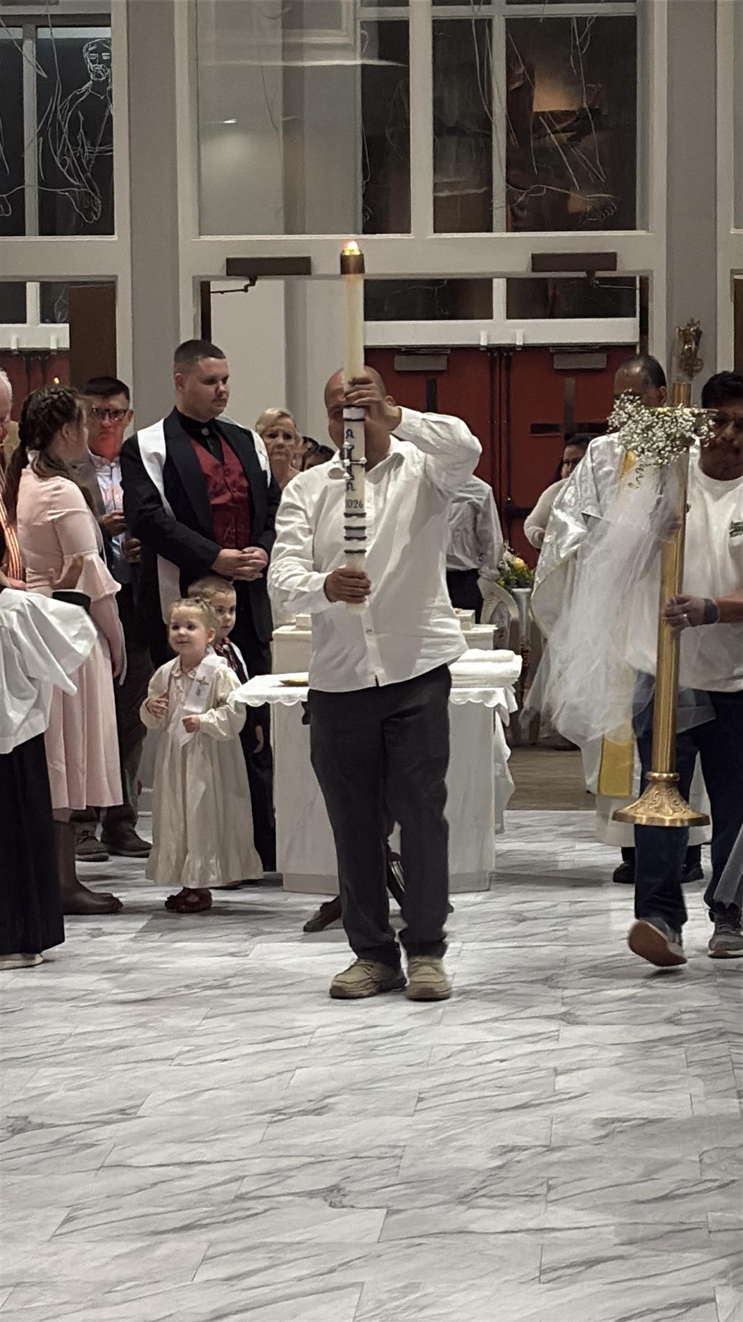 New Catholics process to the front of the church