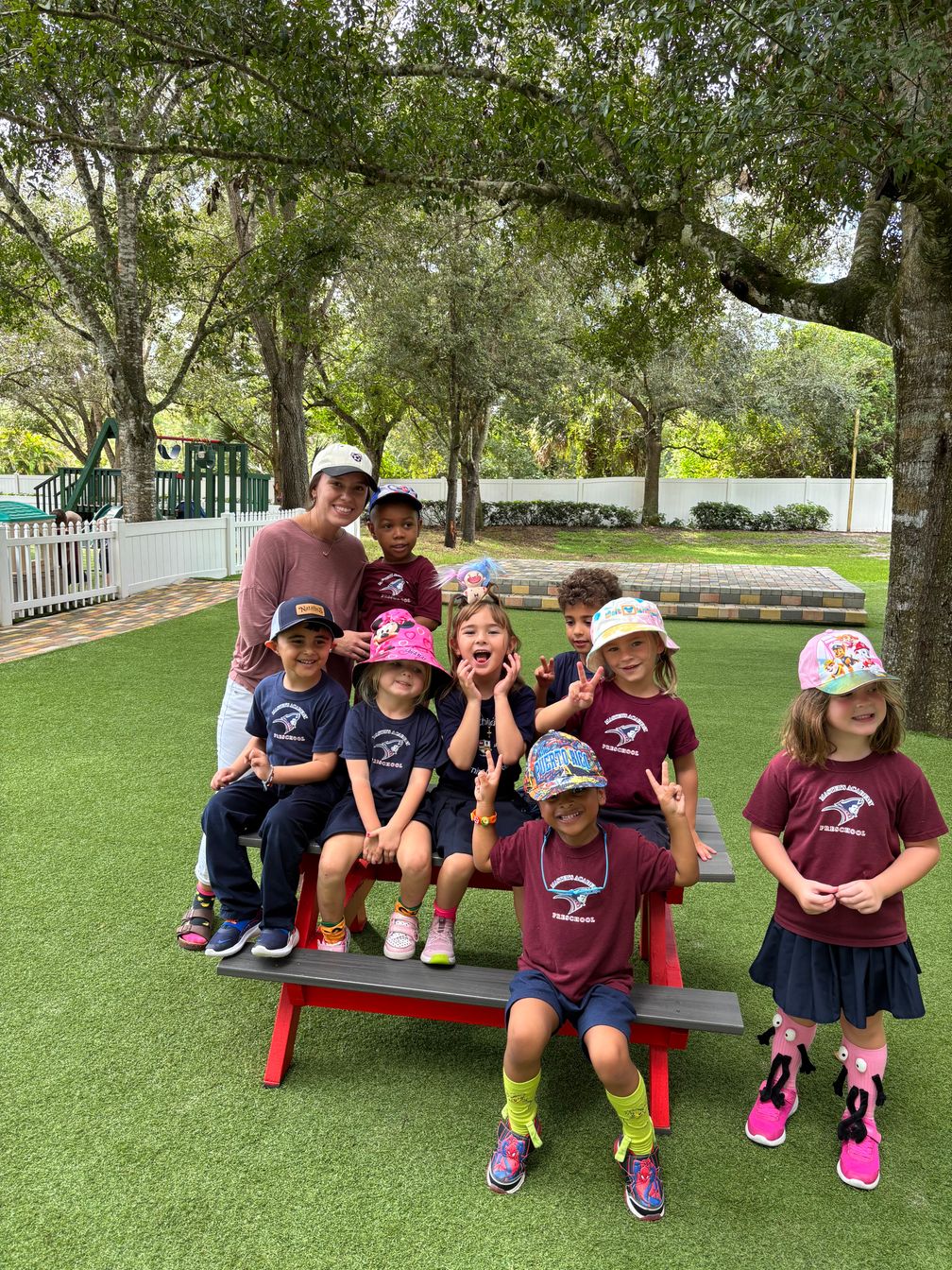 early childhood students outside on table