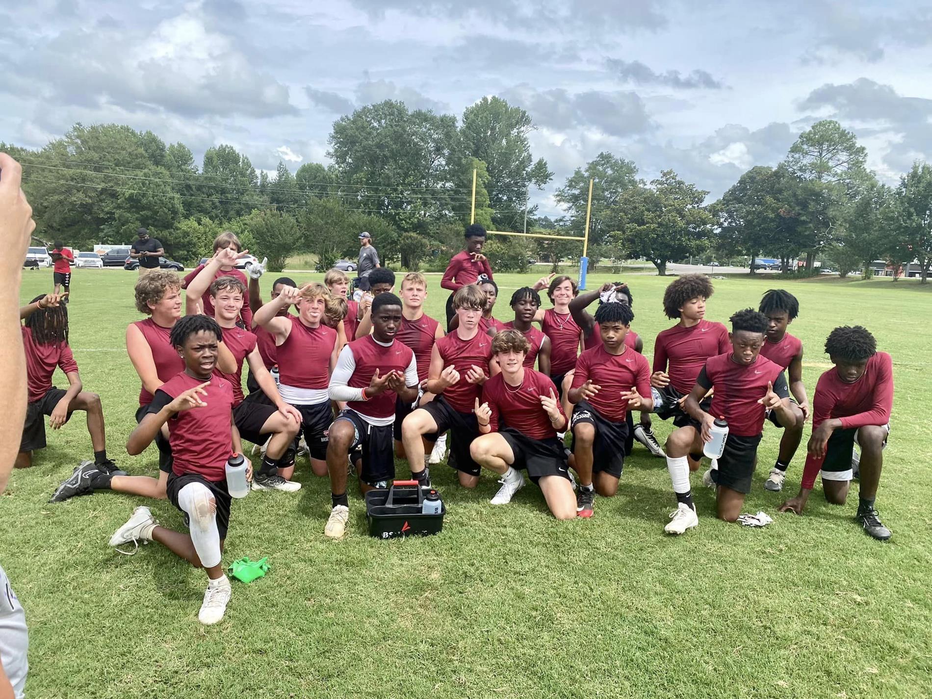 8th football players pose after clanton 7 on 7