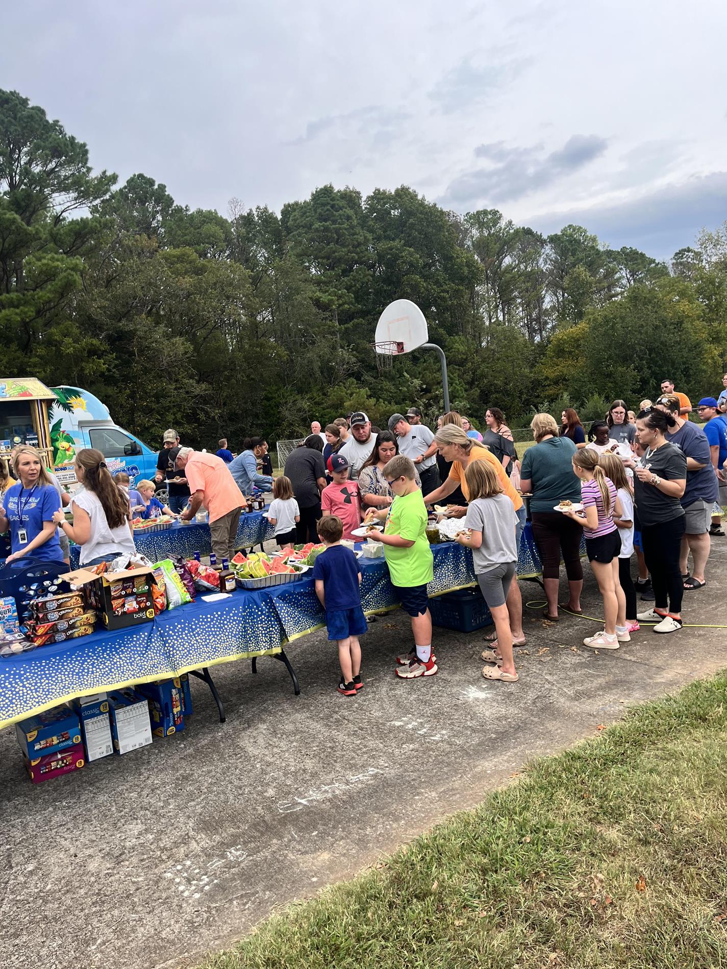 Students, staff, and parents in line to get food