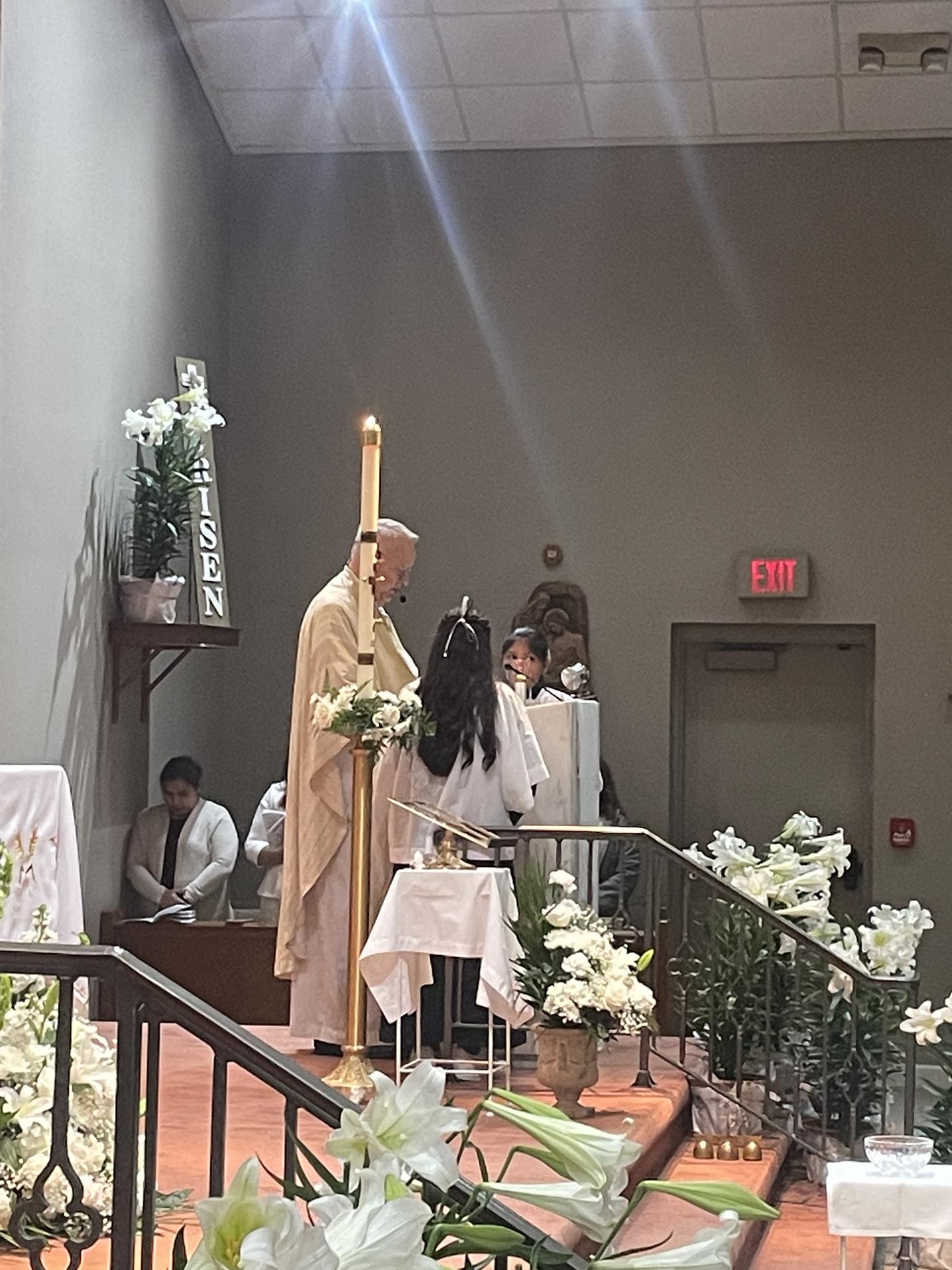 Father Wayne proclaims the Gospel