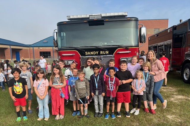 students in front of a fire truck