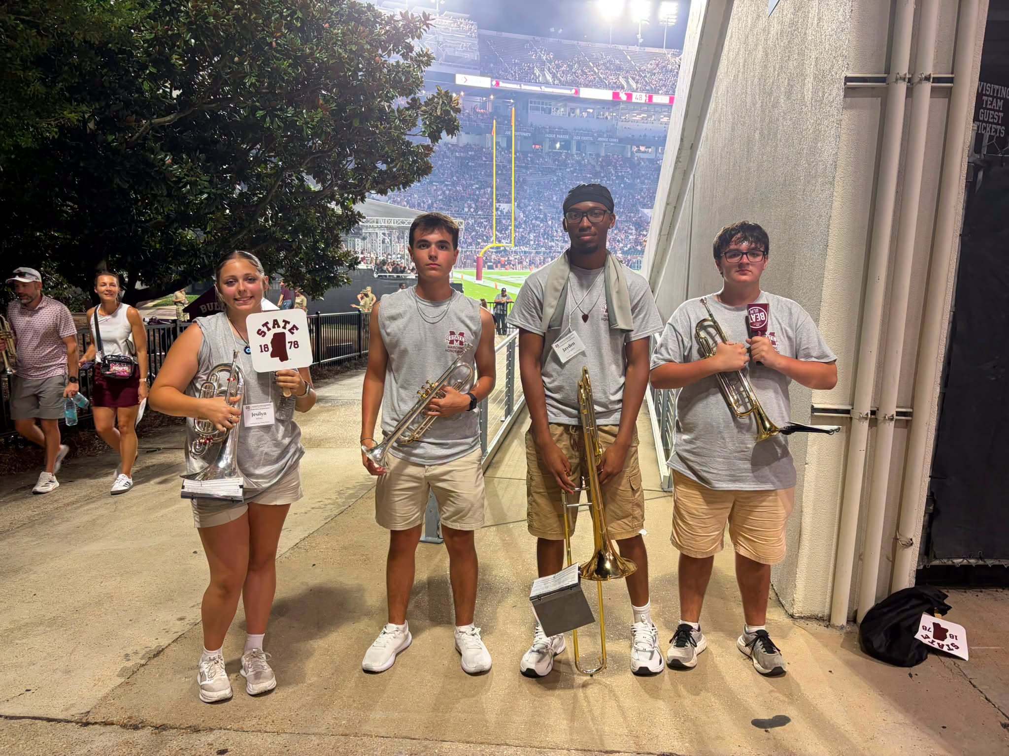 Grant Fremin, Brayson Krier, Jayden Lampkin, and Jesilyn White pose with their instruments at Mississippi State University after participating in the Marching Honor Band and performing with the Famous Maroon Band at halftime.