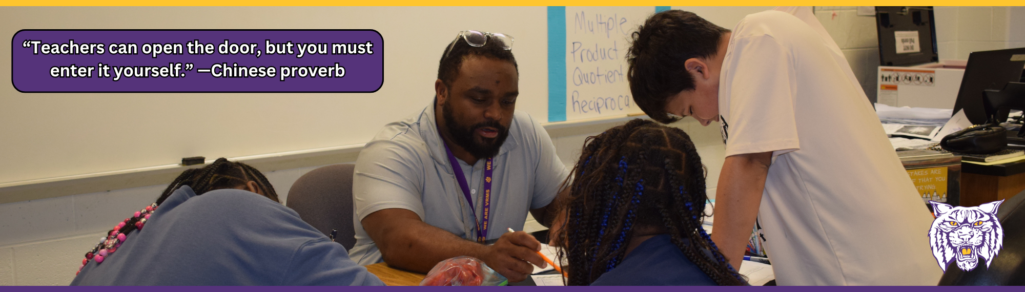 Mr. Jones and students working. Quote: “Teachers can open the door, but you must enter it yourself.” —Chinese proverb