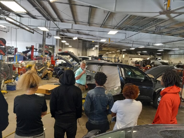 Collision Repair Students on a field trip to Capitol Body Shop viewing body work being done