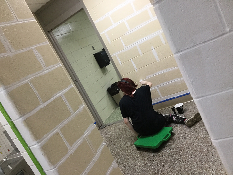 Students volunteering to help paint