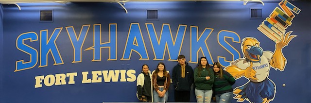 Students in front of Skyhawks sign