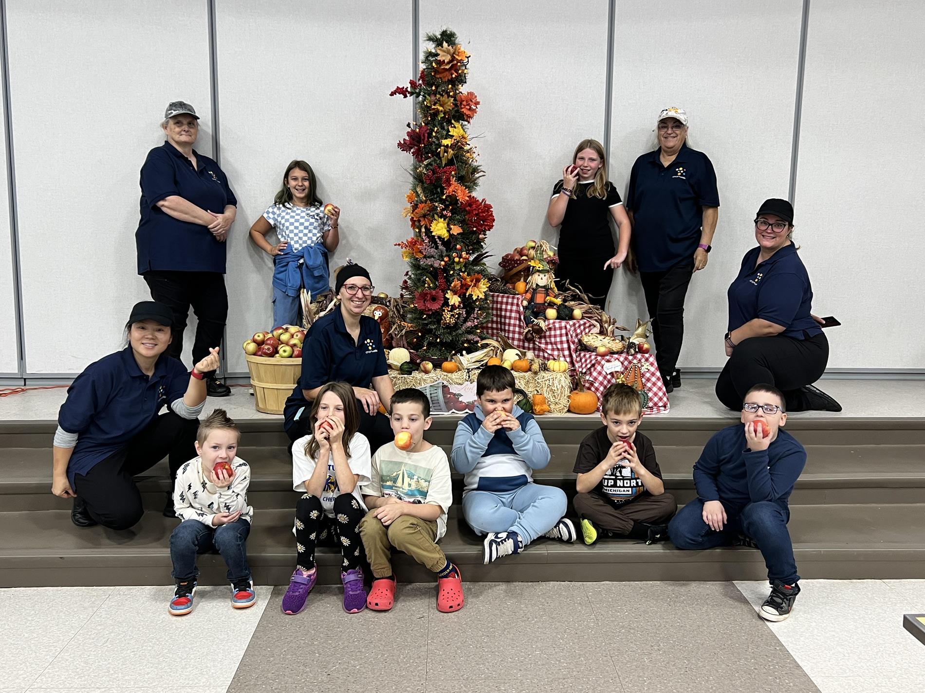 Group of young students holding apples for Apple Crunch Winners
