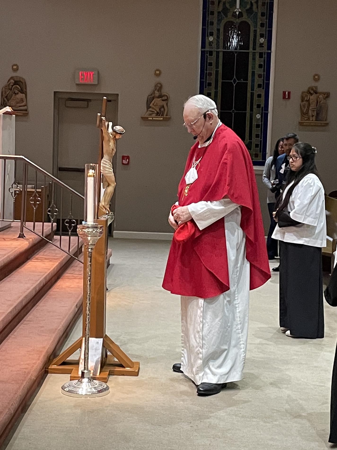 Father Wayne places the crucifix for adoration