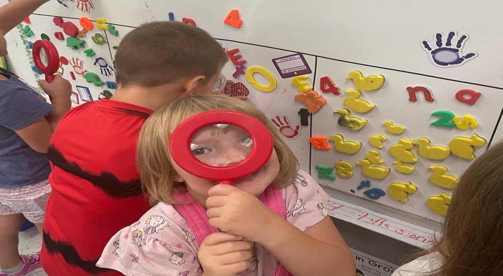 Kindergarten using detective gear to search out letters