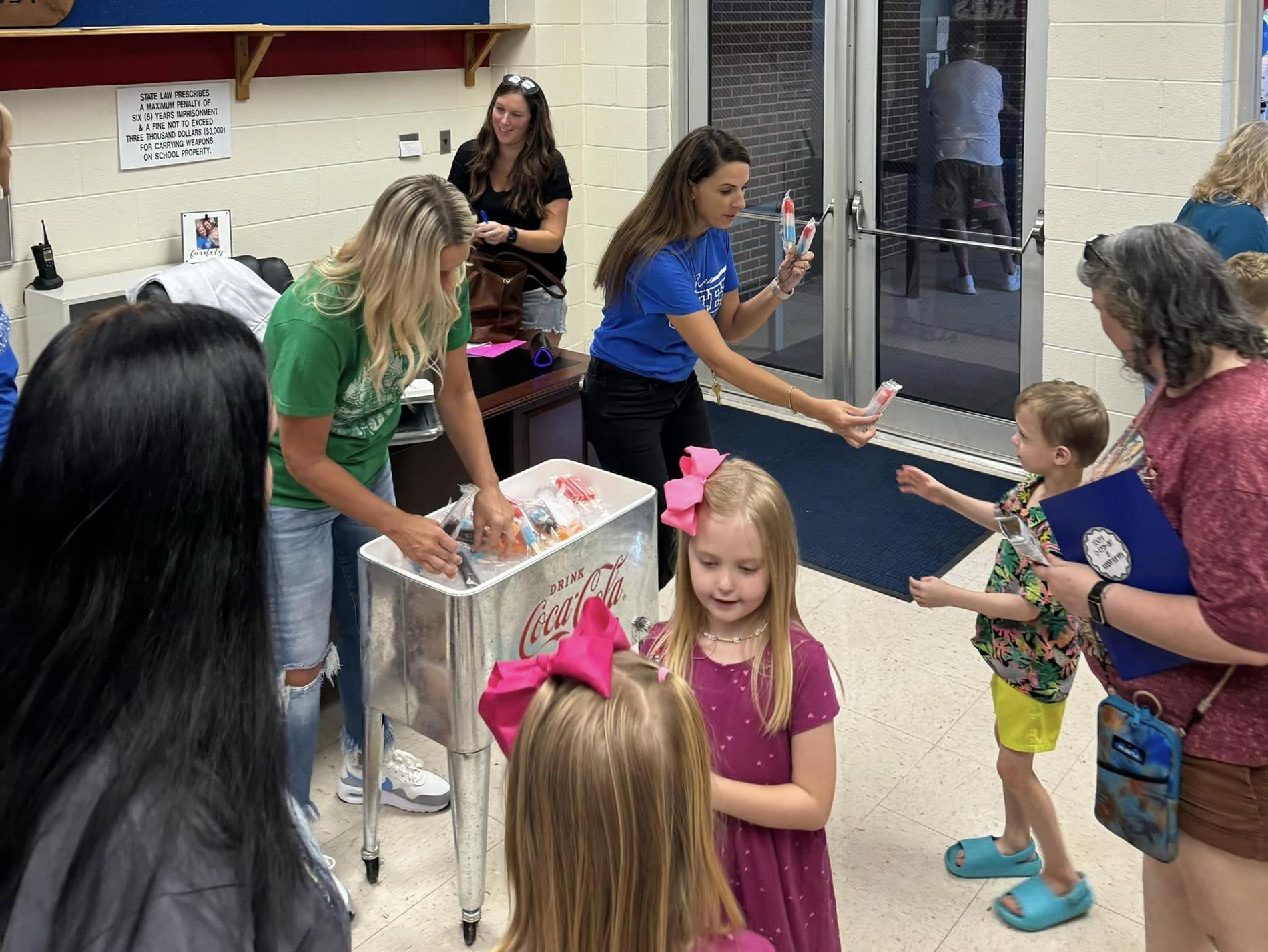 teachers handing out popsicles to students
