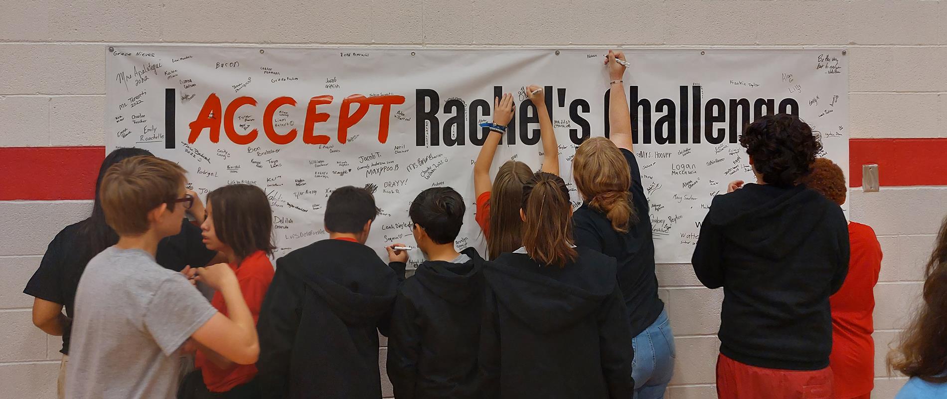 Students signing the Rachel's Challenge banner after presentation
