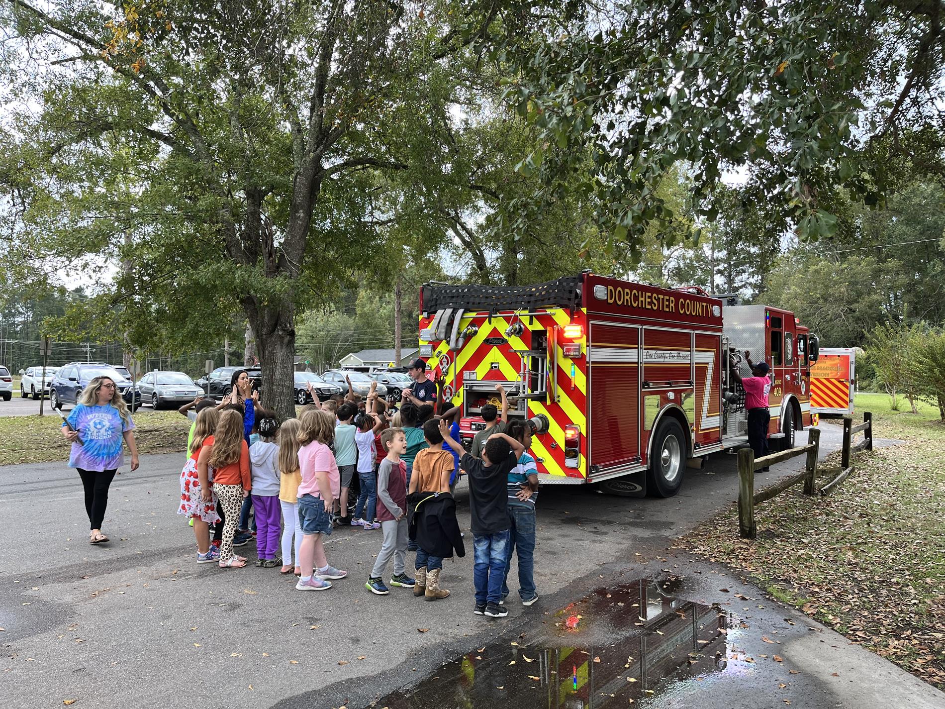 elementary students looking at fire truck