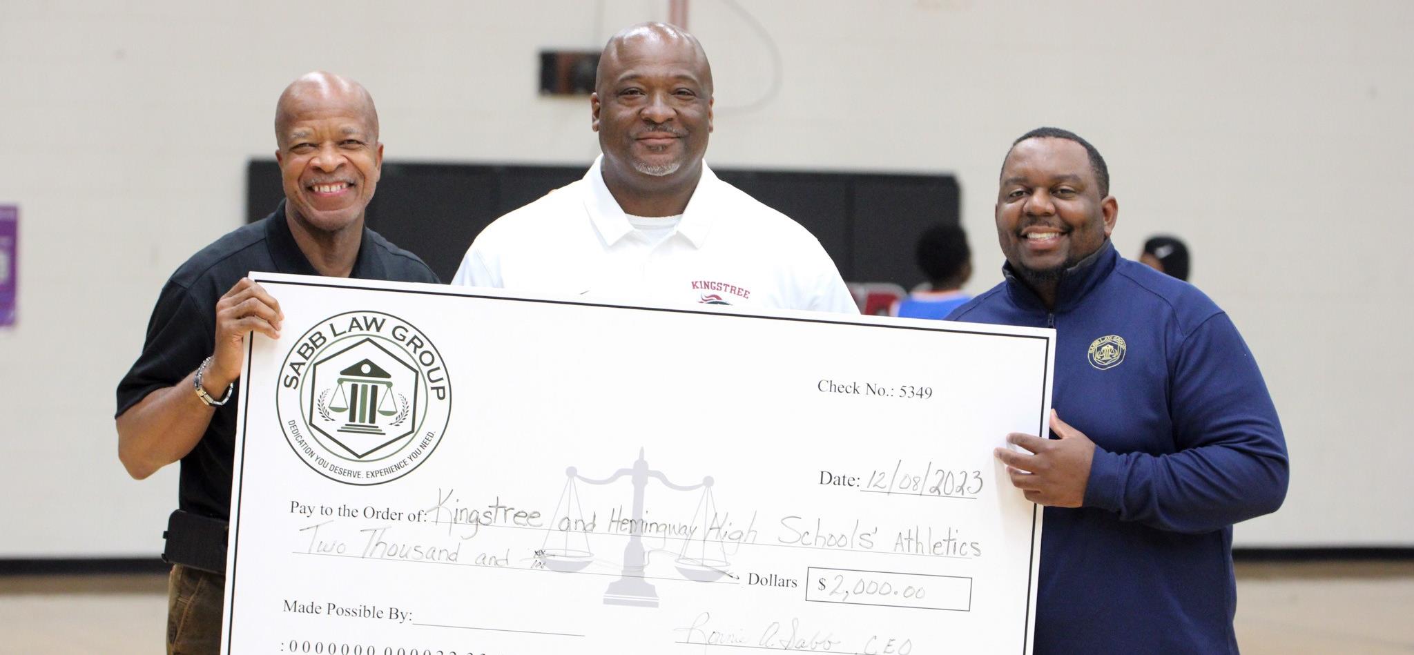 Sabb Law Group presenting a check for $2,000 to Kingstree High School Athletics 