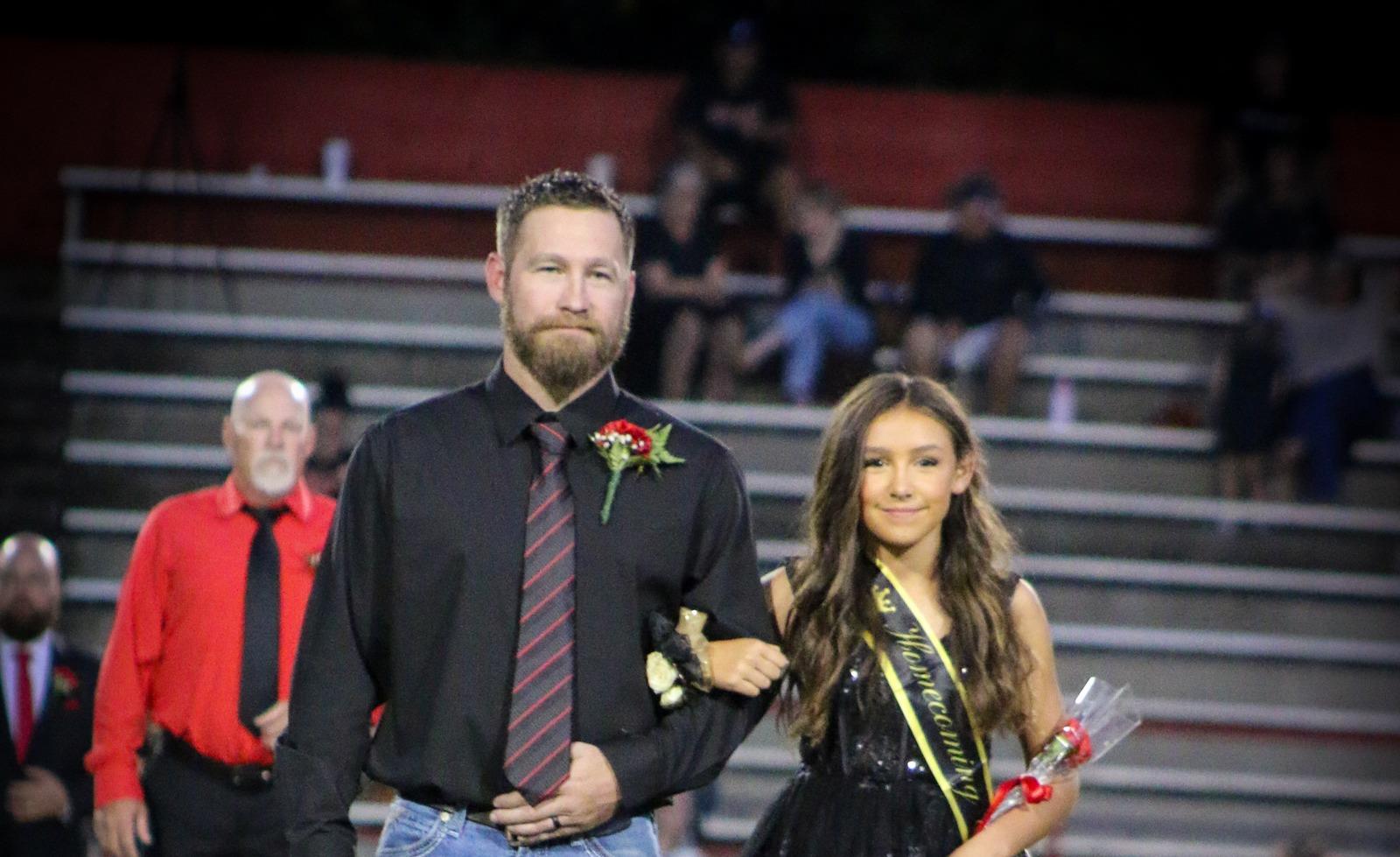 Homecoming attendant in a black dress with escort