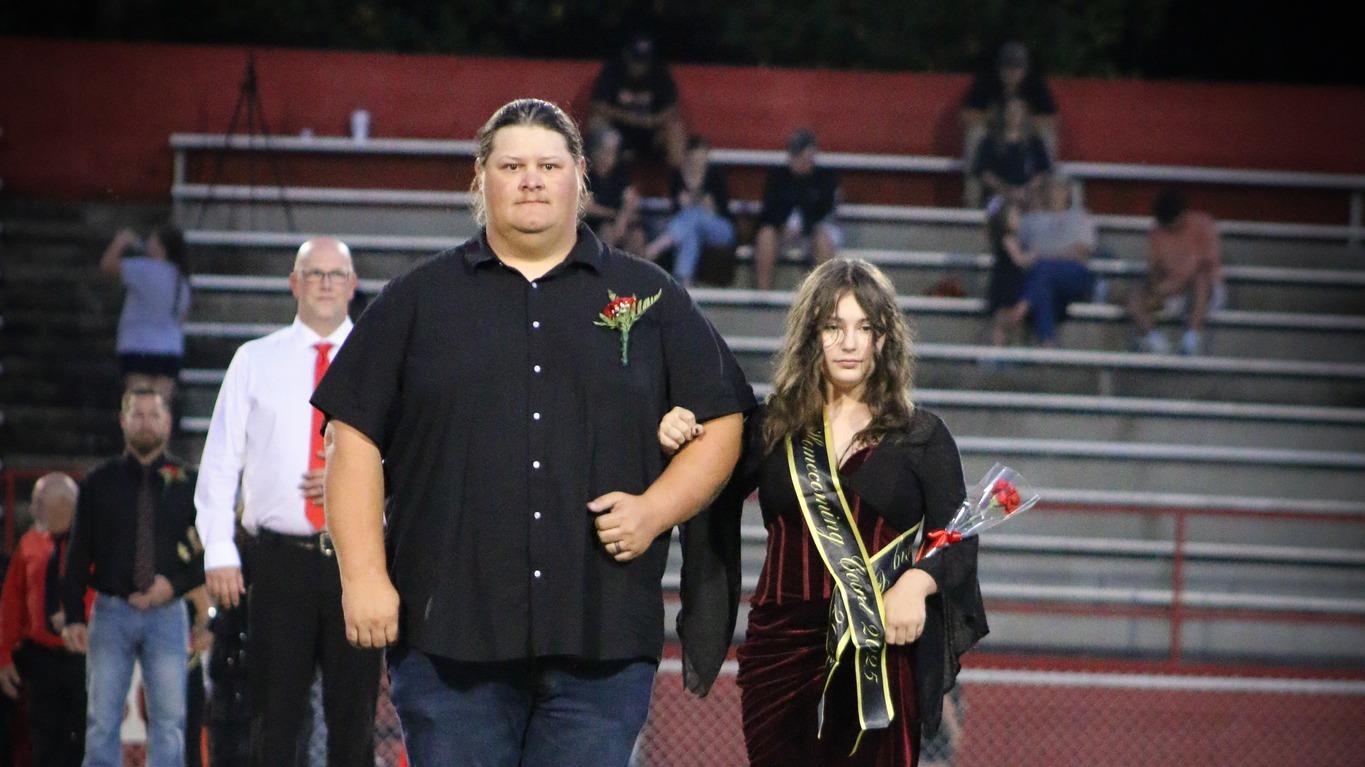 Homecoming attendant in a black dress with escort