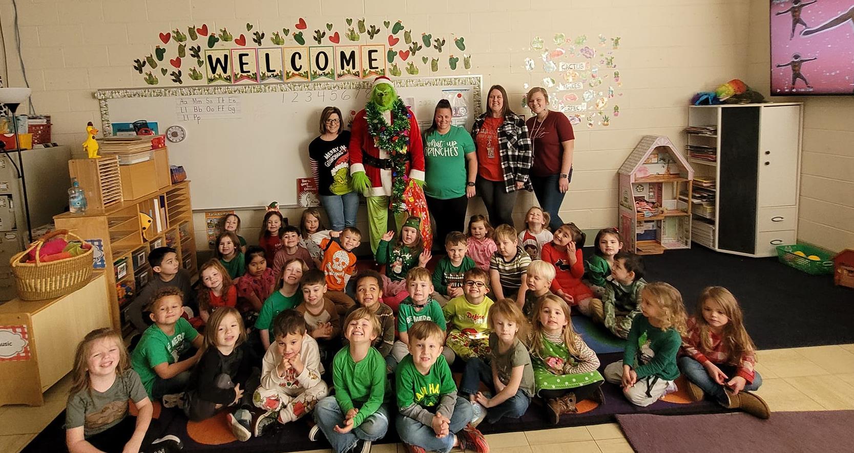East Elementary students posing with the grinch