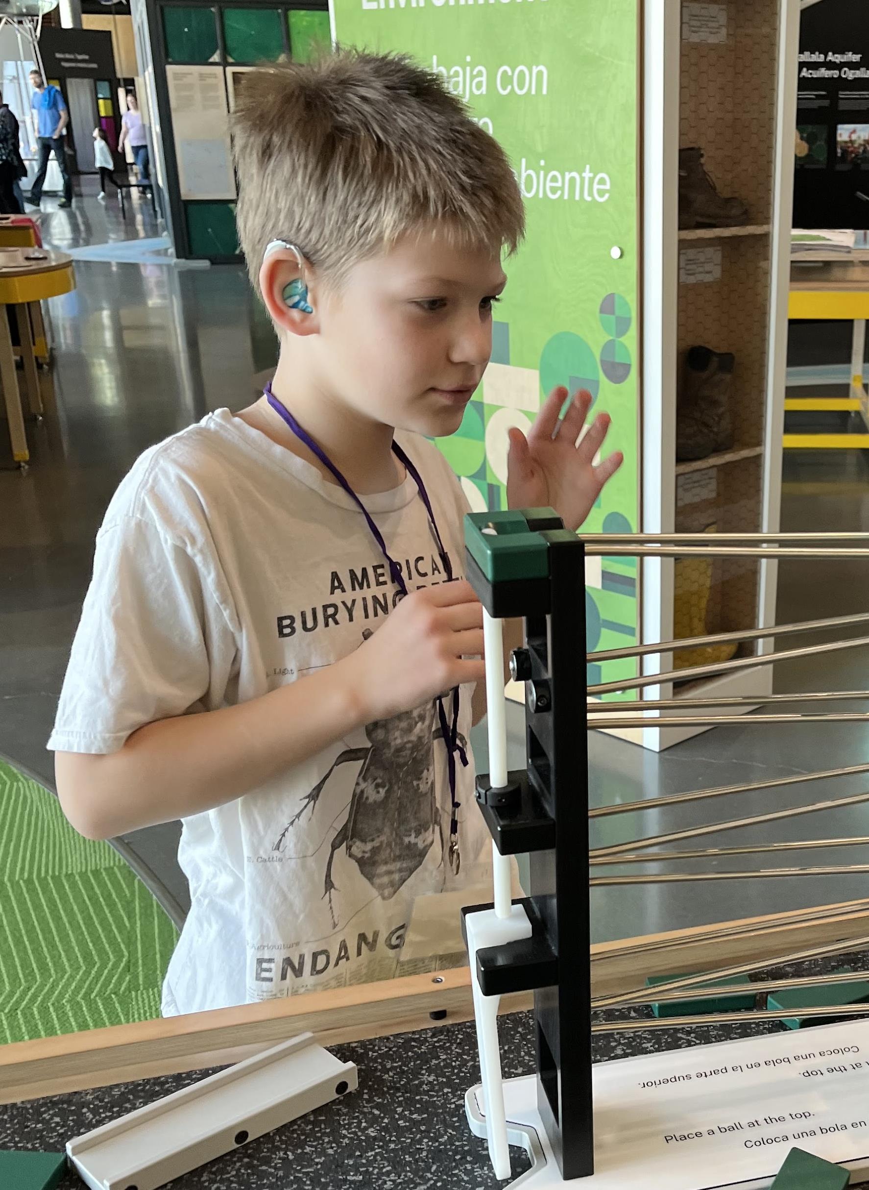 boy doing an experiment at a science museum