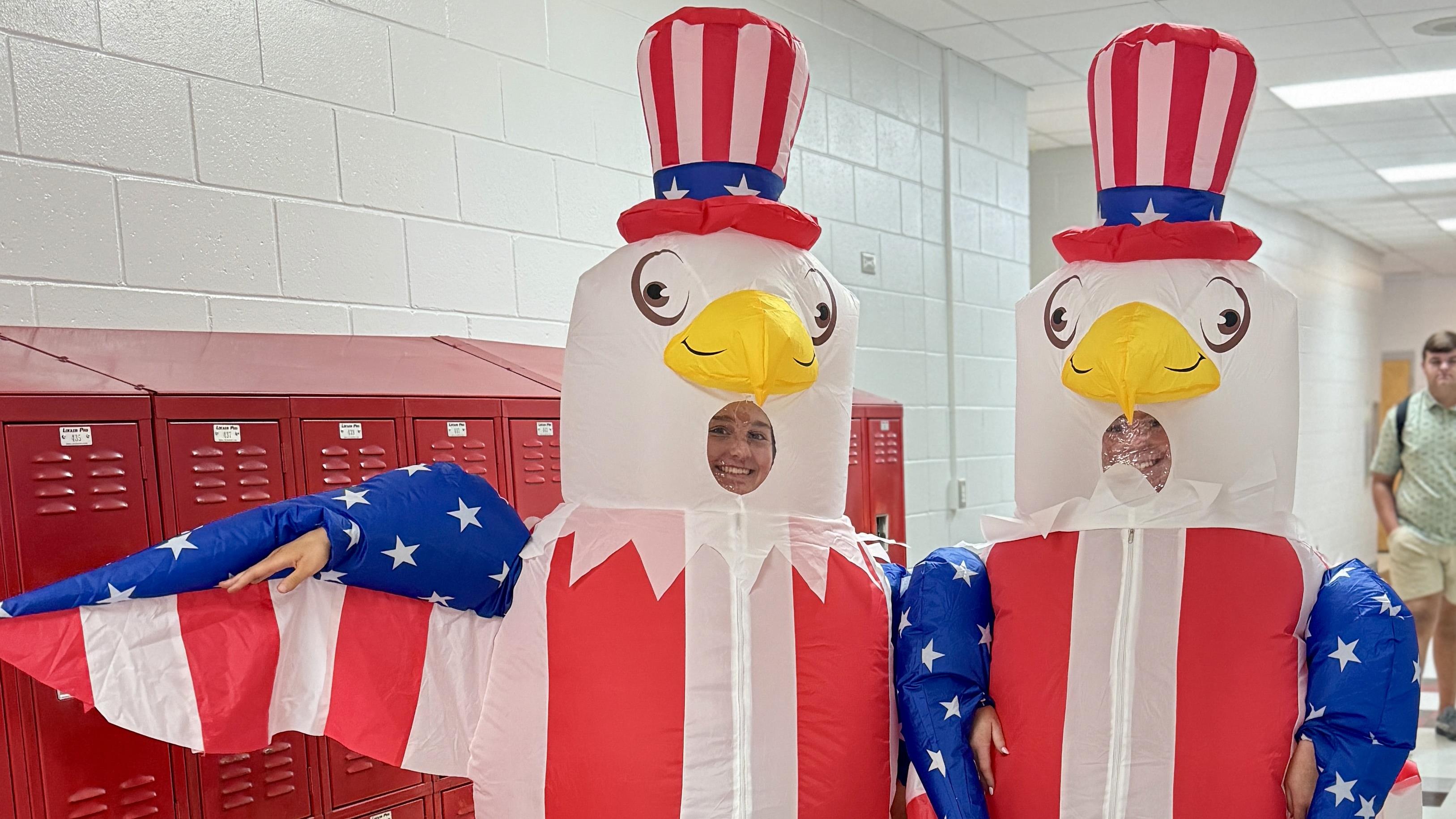 Students dressed up in blow up eagle suits