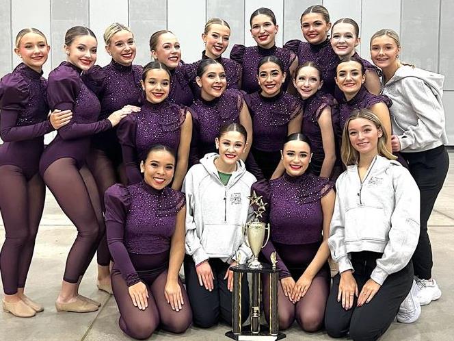 Cougann dance team poses with State Championship trophy.