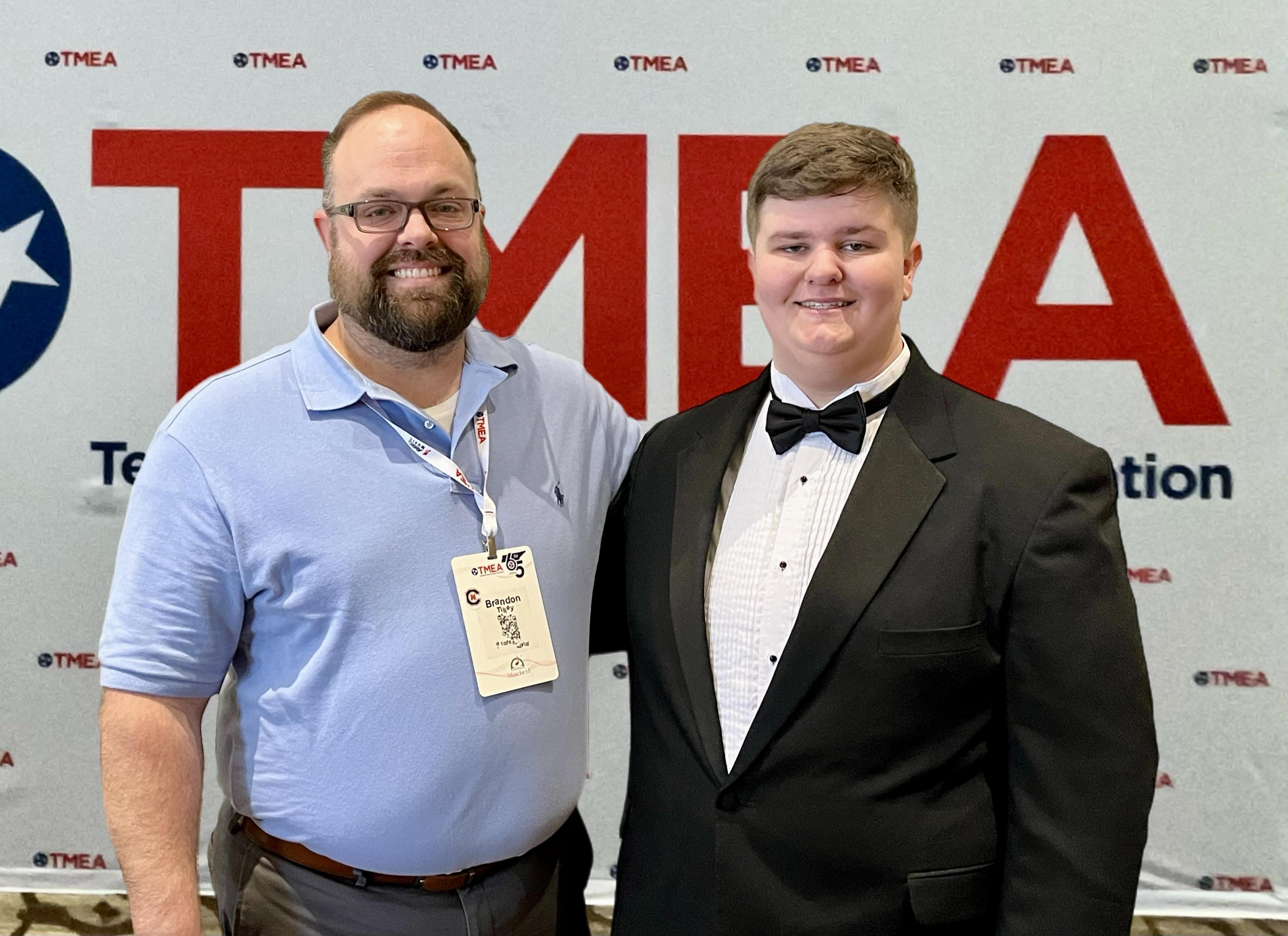 student and teacher in front of TMEA background