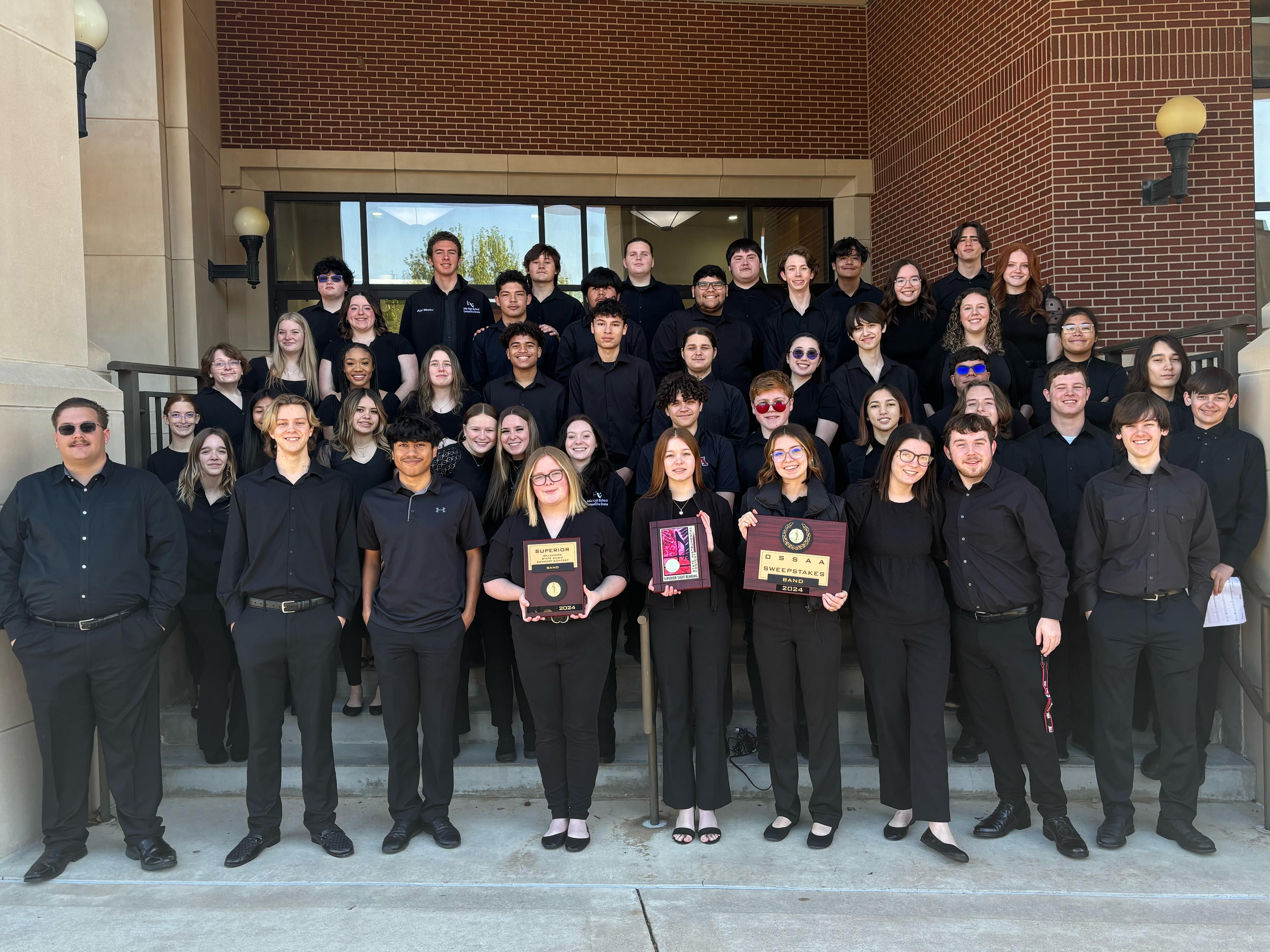 High School band students pose with awards
