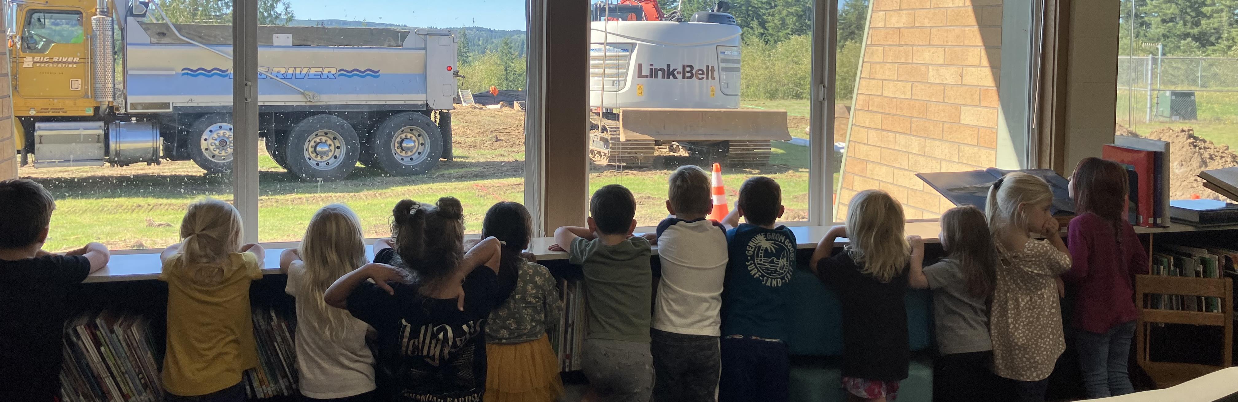 HLE Students watching Big River work on our new Gym and Playground. 